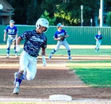 Jackson Boonstra rounds 3rd base and looks to see where the ball is before stying put. 