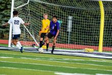 Ethan Christensen blocks the ball before it can get to the net and goalkeeper Reid Herbold. Herbold blocked many shots on the goal during the Freeman Academy game Aug. 27. Photo by Peterman Sports Photography • photoman@iw.net