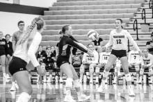 Kate VanRooyan (middle) hits the ball to setter Logan Miller (not pictured) as Claire Munch watches the ball. Photo by Peterman Sports Photography • photoman@iw.net
