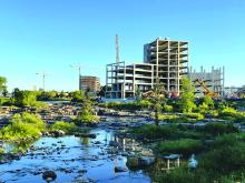 New multi-floor buildings are being built along the Big Sioux River in Sioux Falls near Falls Park. Photo by Charles Odson