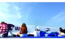 Jordan Pace, Kate Kenny and Kendy Delaney work on painting the barricades. Submitted photo