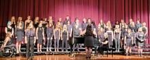 The DV high school choir sang This is Me by Pasek &amp; Paul and arranged by Mac Huff. Freshman Emma Pringle is at the left microphone and Jalen Doyle is at the right microphone with Grace Powell behind her. Other soloists during this song were Maylee Rose, Kali Nichols and Emily Carlson. Photo by Kelly Riibe • times2reporter@gmail.com