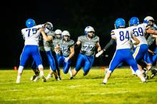 Ty Trometer blocks the way for Lucas Hueser to get closer to the endzone. Photo by Peterman Sports Photography stevepeterman5@gmail.com