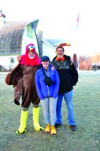 Phil Breed, Abby Romo and Kelly McPhillips are pictured above. The memorial Turkey Trot run was to honor Abby's husband who passed away in May of 2022. Her husband, David Romo, was a member of the Missouri River Runners club. (Bottom) Runners at the Turkey Trot at Adams Nature Preserve. Photo by Kelly Riibe • times2reporter@gmail.com