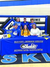 Josie Curry, middle, was surrounded by family, friends and teammates as she signed her national letter of intent to participate in Track at South Dakota State University. Pictured are, front from left, Andy Curry (father), Josie Curry and Melissa Curry (mother); and back, Kenna Curry(sister), Tom Curry (grandfather) and Patricia Curry (grandmother). Submitted photo