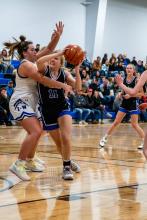 Grace Peed shows determination as she goes to the basket against Irene-Wakonda Dec. 27. She had 5 points on the night. Photo by Peterman Sports Photography • stevepeterman5@gmail.com