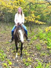 Rachel Bryan rides her horse Neville on a trail ride in Newton Hills State Park.