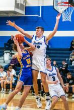Alex Scarmon defends the hoop against Alcester-Hudson Jan. 6. Photo by Peterman Sports Photography stevepeterman5@gmail.com