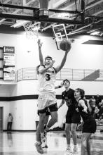 Isaac Bruns makes a strong move to the basket against Sioux Falls Christian Jan. 26. He racked up 26 points by the end of the game. Photo by Peterman Sports Photography stevepeterman5@gmail.com