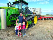 Joey Hanson’s sons come for a quick visit while their dad strip tills a field. Joey Hanson has owned and operated Diversified Agronomy for 10 years. Submitted photo
