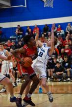 Kayden Moore takes a charge from Vermillion’s Zoan Robinson. Photo by Peterman Sports Photography stevepeterman5@gmail.com
