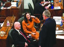 South Dakota Sens. Helene Duhamel and Jim Mehlhaff, both Republicans, speak with Sen. Reynold Nesiba, a Democrat, on Jan. 10, 2023, at the state Capitol in Pierre.