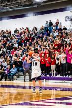 The crowd waits in surprised anticipation as senior Austin Weber sets himself up to launch a 3-pointer. Photo by Peterman Sports Photography stevepeterman5@gmail.com