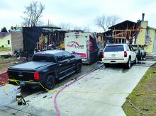 Pictured are two of the homes involved in Tuesday night’s fire. The house on the left was the initial house fire that damaged two other homes. The home on the right is one of the homes damaged by fire. Four vehicles, parked in the driveway, were also damaged in the fire. Photo courtesy of North Sioux City Fire Department