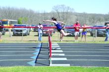 Claire Munch shows perfect form as she clears the last set of hurdles to take 1st place at the Homer Invitational April 13. Photo by Kelly Riibe • times2reporter@gmail.com