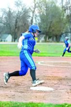 Nicole Wells rounds third on her way home to score a point for the Huskies. Photo by Peterman Sports Photography stevepeterman5@gmail.com