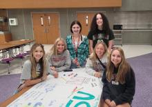 A few DV senior girls signing their names under college emblems that showcase their plans for the fall. Pictured are, from left, are Emily Jumper, Ena Fredericksen, Shalyn Beavers, Rylee Jensen, Emma Wiese and Mackenzie Keizer. Photos by Kelly Riibe • times2reporter@gmail.com
