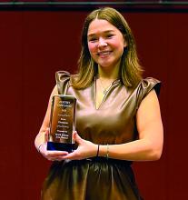 Grace Powell smiles as she showcases her State Championship trophy from Poetry Out Loud. Submitted photo