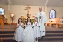 St.Teresa of Calcutta Parish celebrated their First Communion April 30.Pictured are,front from left,Paelyn Kratz, Aubryana Becerra, Emersyn Mozak,and Father Joe Vogel.Eli Taylor and Emersyn Mauch are not pictured,but had received First Communion earlier. PhotobyPetermanPhotography•stevepeterman5@gmail.com