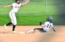 Mia Riibe slides safely into third base against Mitchell. Photo by Randy Uhl