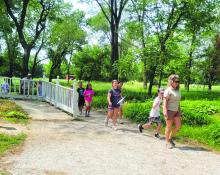 Park Manager Jody Moats leads campers through the Adams Homestead and Nature Preserve on Wednesday, June 14.