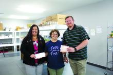 First Dakota National Bank Branch Manager Amanda Beringer, left, and Jones Food Center Store Manager Joe Hall, right, present Elk Point Food Pantry Director Tam Edgar, middle, with donation checks of $3,102.39 from Operation Round-Up for the food pantry. Photo by Beth Hutcheson • times1reporter@gmail.com