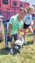 Oliver Scott, of River-R-Land in North Sioux City, pets a baby goat while at the NSC Library’s summer reading bike rodeo and kick-off event. Photo by Kelly Riibe times2reporter@gmail.com