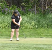 Senior Lexi Squier putts during the conference meet in Vermillion May 22. Photos courtesy of Randy Uhl