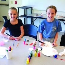 The North Sioux City Community Library hosted a Walk-in Craft Day July 12. Kids were able to use their imaginations and decorate yo-yos. Pictured are, from left, McKinley Koedam and Brynn Christensen. Photos by Kelly Riibe • times2reporter@gmail.com