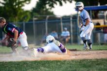Beau Jones slides head first into home plate to earn a run for the Panthers. Photo by Peterman Sports Photography • stevepeterman5@gmail.com