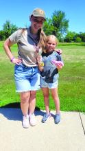 Naturalist Intern Maddie Kallsen takes a photo with Emmersen Carreau at the Adapting Animals Nature Camp. Photo by Kelly Riibe • times2reporter@gmail.com