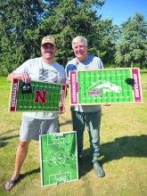 Jim and Jerry Braunschweig hold the three versions of their Flickboards. The soccer Flickboard at their feet was the first one ever made for Jim’s son Brady. Jim (on the left) is holding the newest version, while Jerry (right) holds on of the boards they handmade in their garage since 2015. Submitted photo