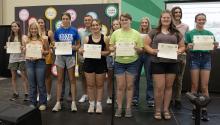 Carley Crist is pictured here receiving her certificate. She is in the second row, and is the second from the right.