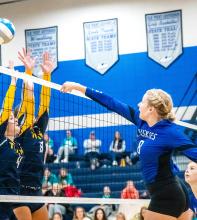 Grace Peed’s ball goes sailing over the net and the Titan’s blockers for a kill on Oct. 16. Photo by Peterman Sports Photography • stevepeterman5@gmail.com
