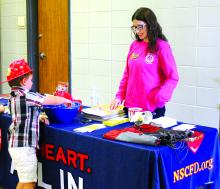 Harrison Wren of Dakota Dunes stops at the fire prevention information booth for some candy and activity packets. See more photos on page 12. Photo by Beth Hutcheson • times1reporter@gmail.com