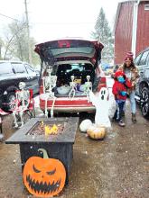 People braved the cold and first snow of the season on Oct. 28 to participate in Jefferson’s Trunk or Treat. This vehicle was decked out with skeletons trying to stay warm by a fire pit.  Submitted photo