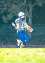 Ashton Fairbanks gets a 45-yard pick 6 to help secure the win for the Huskies Oct. 26 against Tri-Valley. Photo by Peterman Sports Photography • stevepeterman5@gmail.com