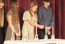 Josie Eckhardt, next to a few fellow Panther seniors, lights a candle during Dakota Valley’s NHS induction ceremony on Oct. 16. Pictured are, from left, Sophie Tuttle, Kyli Vaske, Josie Eckhardt and Brayden Karkalik. Submitted photo