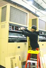 Jayse Vande Vegte works on an electrical unit attached to one of Thermo Bond’s structures. He is interning with Thermo Bond and hopes to use his new found skills to become an electrician. Photo by Beth Hutcheson • times1reporter@gmail.com