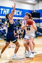 Evan Fornia, pictured here against Canton, had a spectacular game under the hoop in Madison Dec. 9. He scored 13 points for the Huskies had 7 rebounds, 3 assists and 2 steals. Photo by Peterman Sports Photography • stevepeterman5@gmail.com