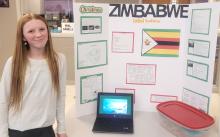 Isabel Bradshaw, of Wynstone, did her project on Zimbabwe for the 7th Grade Culture Fair. She made mapopo (a popular Zimbabwe candy of sliced papaya cooked in sugar) to hand out at the fair. Photo by Kelly Riibe • times2reporter@gmail.com