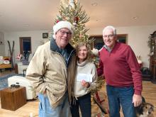 Jay Schenzel (left) also known as Santa Claus around the holiday season, presents Dawn and Dan Heaton with a check for $630 to benefit the Civil Bend Cemetery. Submitted photo