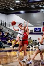 Emersen Mead shows tenacity as she shoots over a Vermillion defender Feb. 6. Photo by Peterman Sports Photography stevepeterman5@gmail.com