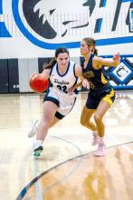 Courtney Brewer shows grit as she dribbles into a Titan defender Feb. 16. Photo by Peterman Sports Photography stevepeterman5@gmail.com
