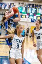 Cera Schmitz attacks the basket and gets 2 of her 16 points against the Titans on Feb. 22.