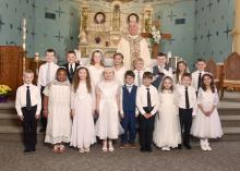 First Communion students for St. Peter and St. Joseph Catholic churches were, from front left, Huxley Haveman, Mya Hammitt, Ashton Donnelly, Leah Donnelly, Miguel Lopez, Reece Chicoine, Ariel Yaneff, Caleb Rupp and Camila Hanson; and back, Hudson Boyle, Raylan Renken, Jenna Sellers, Josie Hutcheson, Keaton Jansen, Bayden Hopper, Annalisa Hanson, Henrik Holgate, and Father Joe Vogel.