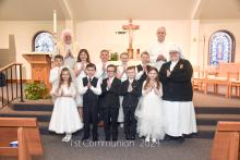 St. Teresa of Calcutta Catholic Church held its First Communion ceremonies on Sunday, April 28. Pictured are, from front left, Audrie Brandon, Kyler Hoefs, Broderick Jennett, Caiden Junck and Maddie Mousel; middle, Matias Smith, Ari Probasco, Greyson Becker, Cora Hunn, Joseph Kreber and Sister Julian; and back, Father Kevin Doyle and Deacon Joe Twidwell. Photo by Peterman Photography • stevepeterman5@gmail.com