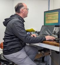 Dakota Valley AD Bill Clements looks over track finish results on April 23 at the Panther’s home meet. Photo by Kelly Riibe • times2reporter@gmail.com