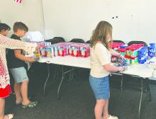 Easton Weaver (left) and Reese Weber (right) selecting cake and frosting for their boxes. Submitted photo
