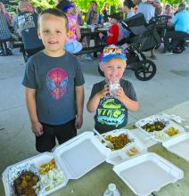The Gutzmann brothers from left, Lewis Gutzmann and Theo Gutzman of Dakota Dunes, enjoyed Kai Thai cuisine at the "Food Trucks in the Park" on June 9th. Photo by Kelly Riibe • times2reporter@gmail.com